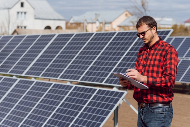 Man standing near solar panels