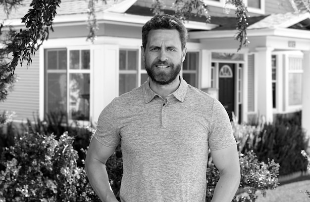 Man standing outside new home portrait of happy mature man looking at camera outdoor senior