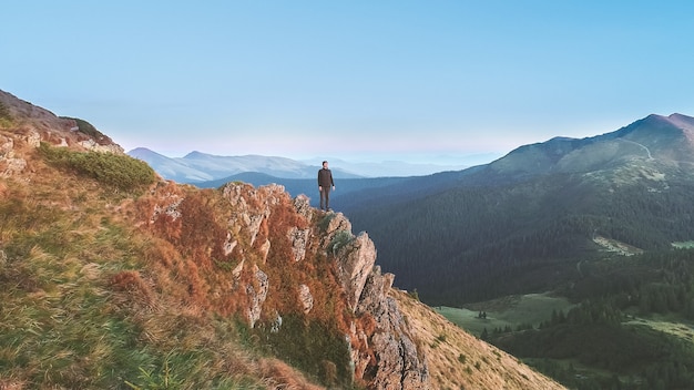 The man standing on the picturesque rock