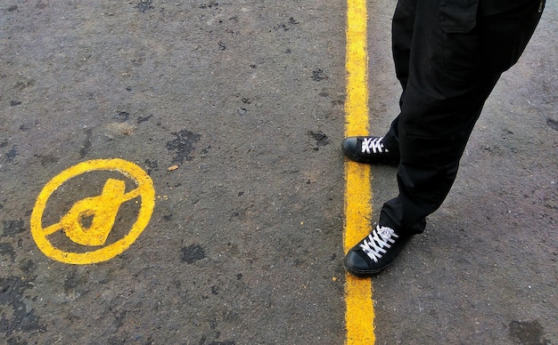 man standing on road marking