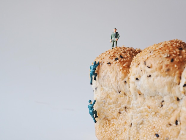 Man standing on rock against sky