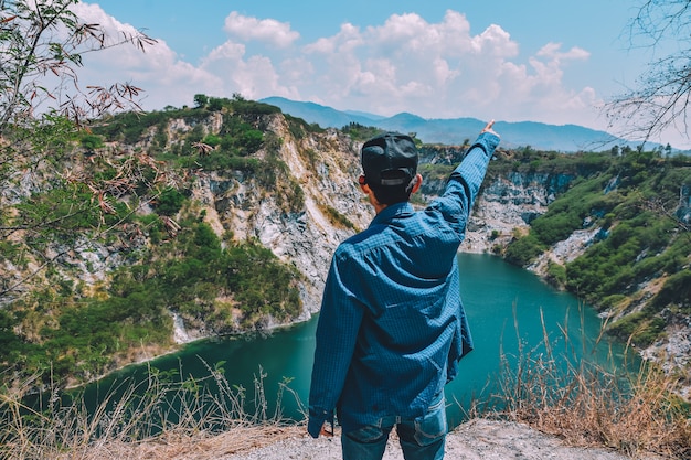 Man standing on rock mountain at lake view