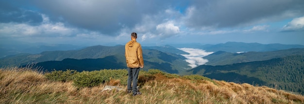 The man standing on the top of a mountain