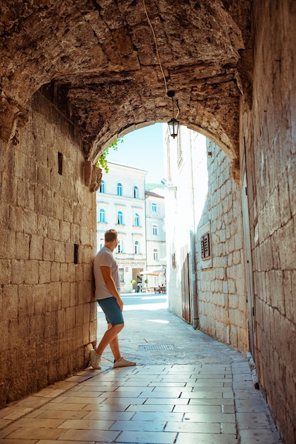 Man standing in tunnel in kotor town