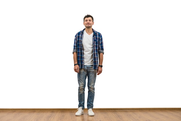 The man standing on the white wall background