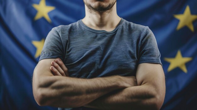 Man Standing With Arms Crossed in Front of European Flag