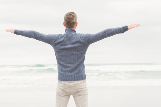 Man standing with arms out wide