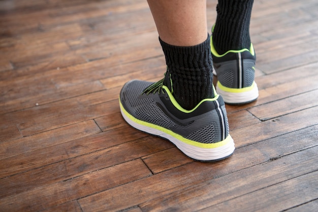 Man standing on a wooden floor