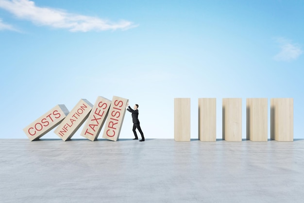 man stopping abstract wooden domino blocks on bright sky background with mock up place crisis recession and challenge concept