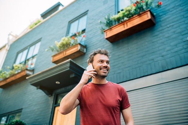 Man on the street using mobile phone