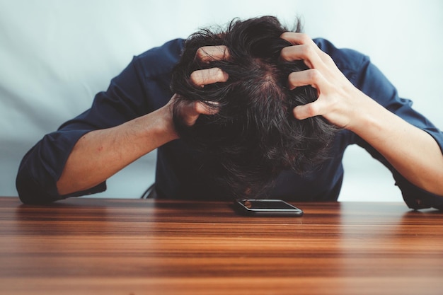 Man stressed with hair loss problem. thinning hair. scalp problems