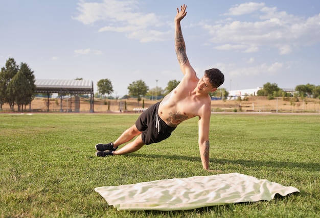 Man stretching on the grass in the park