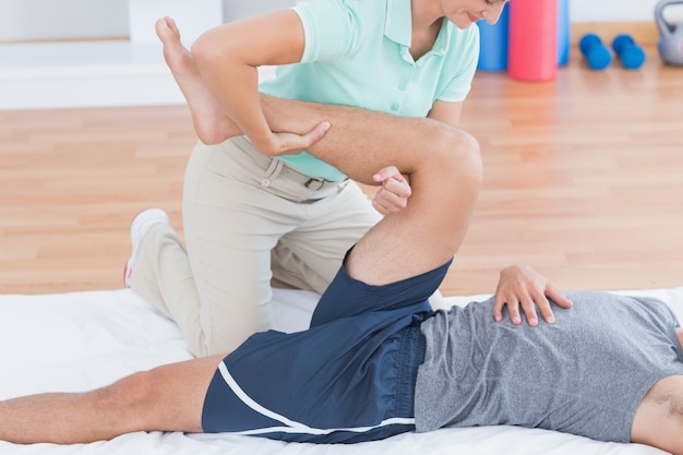 Man stretching with his trainer