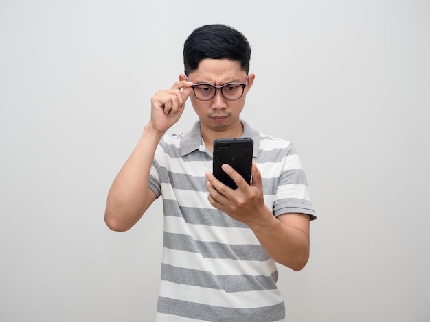 Man striped shirt move glasses for looking at mobile phone in his hand