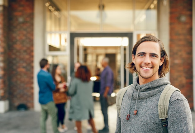 Man student and portrait outdoor with smile or backpack for education learning or development at college Young person happy and bag for scholarship study or pride at university in Munich