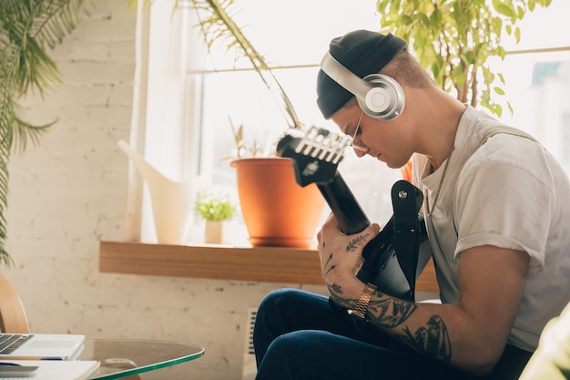 Man studying at home during music online courses