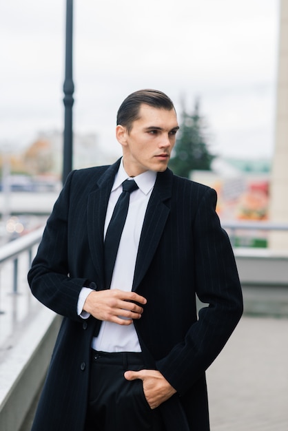 Man in a stylish suit. Businessman in an autumn city, fashion