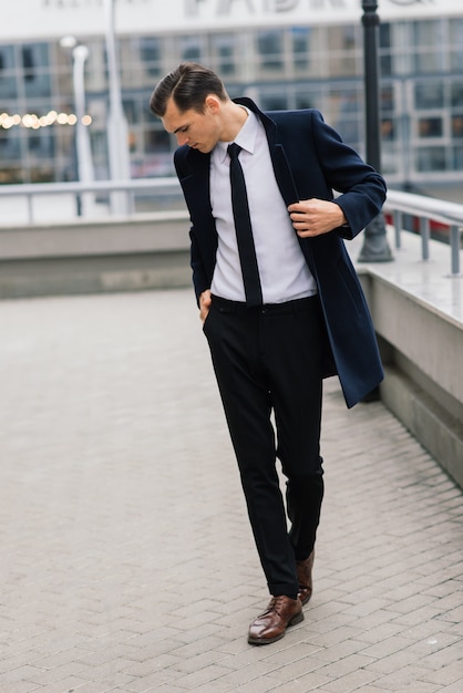 Man in a stylish suit. Businessman in an autumn city, fashion