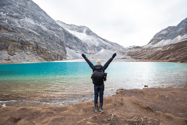 A man success hiking with milk lake, yading Nature Reserve, china