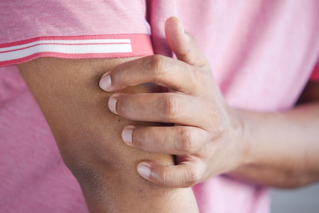 Man suffering from itching skin close up