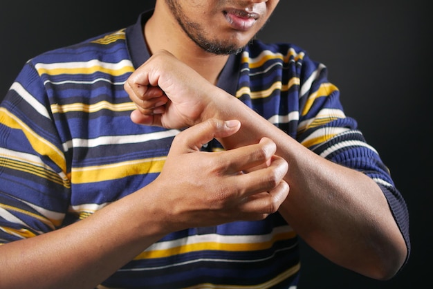 Photo man suffering from itching skin close up