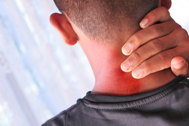 man suffering from neck or shoulder pain at home.