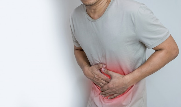 Photo man suffering from stomach ache with both palm around waistline to show pain and injury on belly area