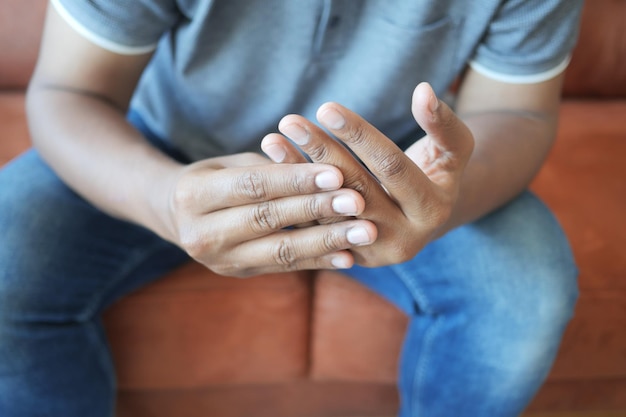 man suffering pain in hand close up