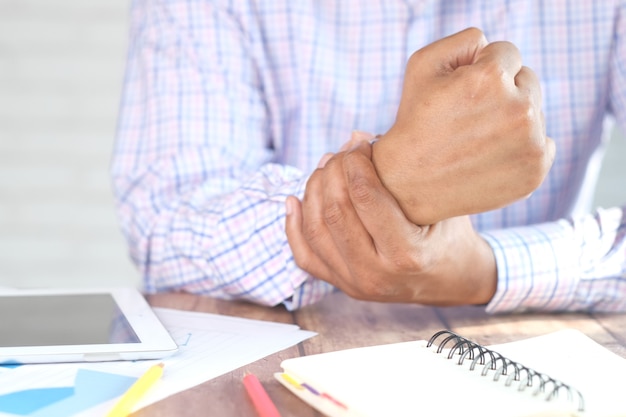 Man suffering pain in hand close up