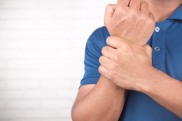 Man suffering pain in hand close up