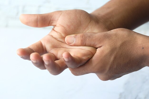 man suffering pain in hand isolated in white