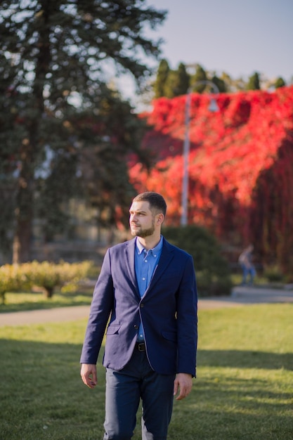 Man in a suit in the autumn in the park
