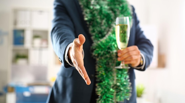 Photo man in suit hold champagne goblet give arm as hello