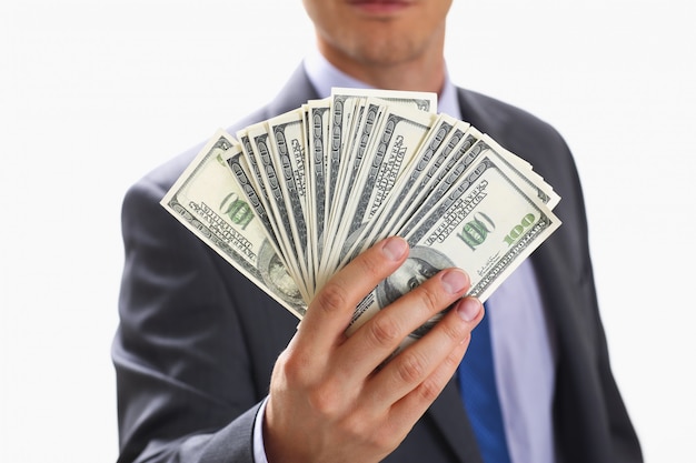 Man in suit hold money