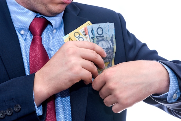 Man in suit holding australian dollar banknotes close up