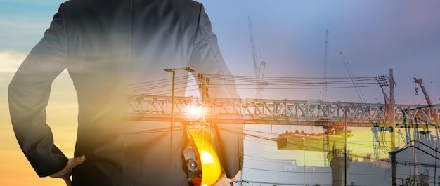 A man in suit holding helmet Industrial and construction design concepts