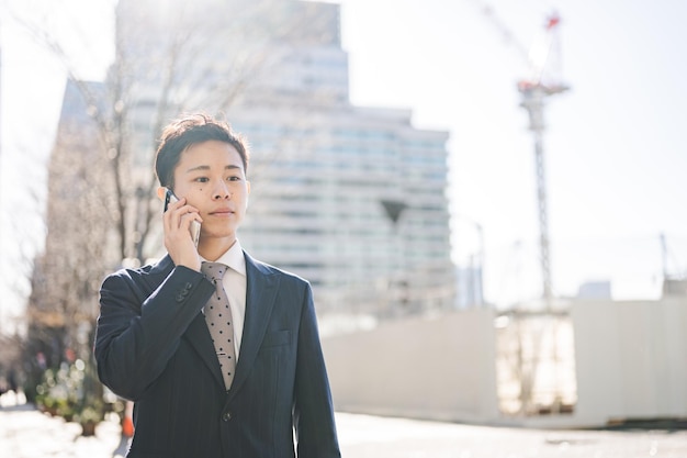 a man in a suit is talking on a cell phone