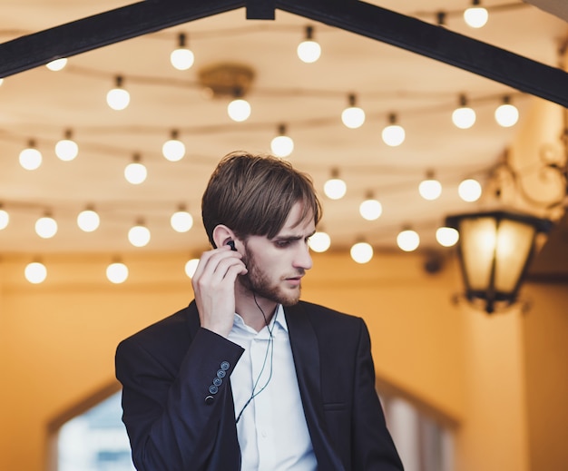 Man in a suit listening to music