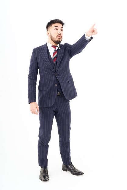 A man in a suit pointing up