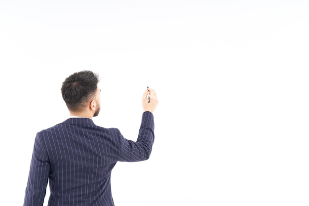 A man in a suit posing to write with a pen