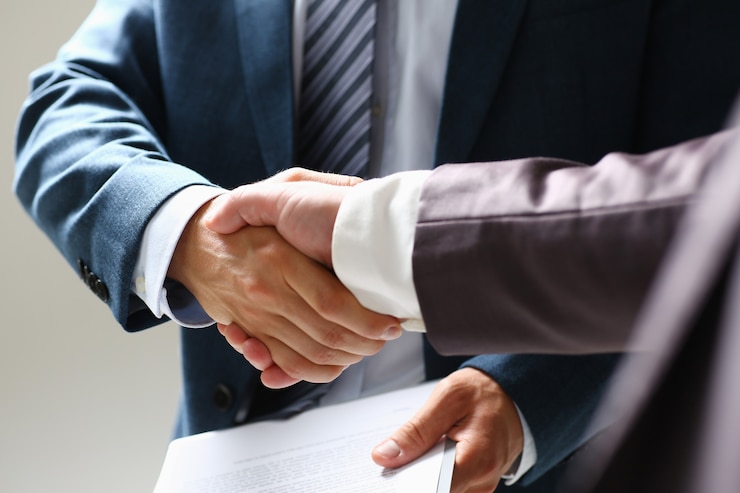 Photo man in suit shake hand as hello in office closeup