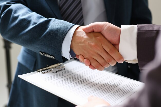 Photo man in suit shake hand as hello in office closeup