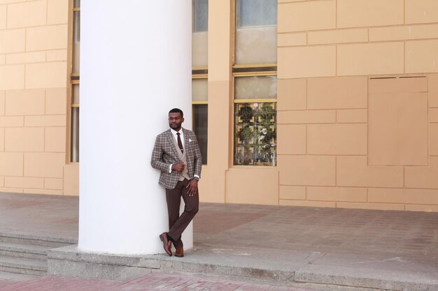 Man in suit standing against building