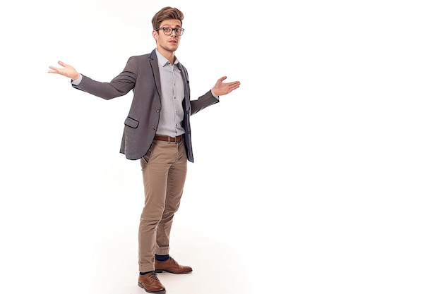 a man in a suit stands in front of a white background