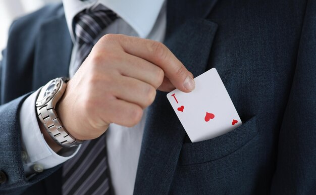 Photo man suit takes an ace card from his jacket pocket