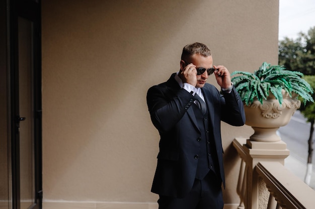 a man in a suit talking on a cell phone