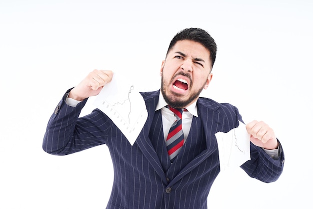 A man in a suit tearing up materials