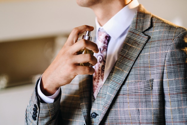 A man in a suit uses toilet water