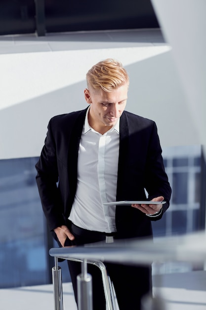 A man in a suit with tablet in his hand the office