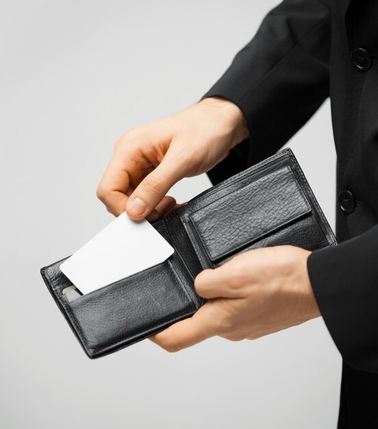 man in suit with wallet and credit card.